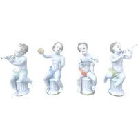 A series of four porcelain musicians seated on columns.