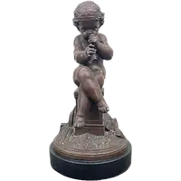 A small bronze sculpture depicting a cherub playing the flute.