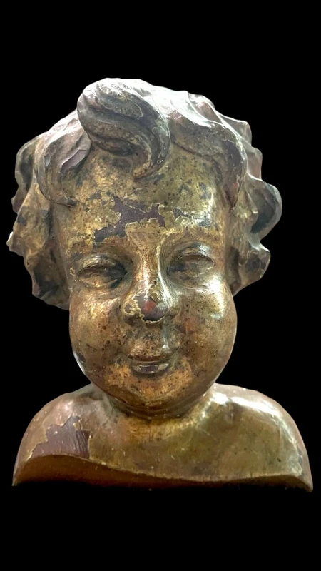Busto di bambino in legno intagliato e dorato a mecca,montato su base lignea.