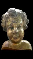 Busto di bambino in legno intagliato e dorato a mecca,montato su base lignea.