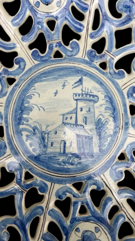 An octagonal plate made of openwork majolica with a monochrome blue rocaille design