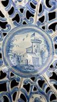 An octagonal plate made of openwork majolica with a monochrome blue rocaille design