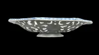 An octagonal plate made of openwork majolica with a monochrome blue rocaille design