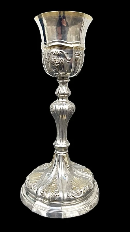 Embossed silver chalice with a tapered globular body decorated with grape cluster motifs