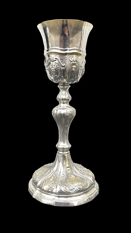 Embossed silver chalice with a tapered globular body decorated with grape cluster motifs