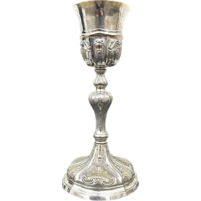 Embossed silver chalice with a tapered globular body decorated with grape cluster motifs