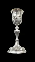 Embossed silver chalice with a tapered globular body decorated with grape cluster motifs