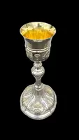 Embossed silver chalice with a tapered globular body decorated with grape cluster motifs