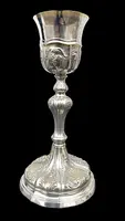 Embossed silver chalice with a tapered globular body decorated with grape cluster motifs