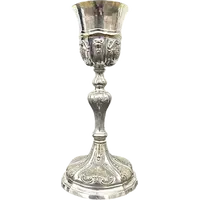 Embossed silver chalice with a tapered globular body decorated with grape cluster motifs
