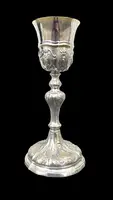 Embossed silver chalice with a tapered globular body decorated with grape cluster motifs