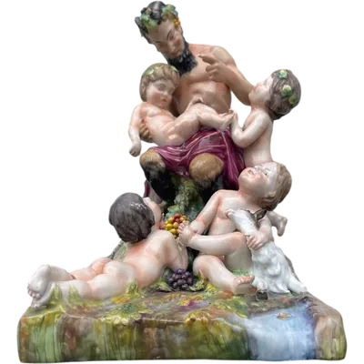 Polychrome porcelain sculpture group depicting a faun and cherubs in a rural setting. Ginori Manufactory.