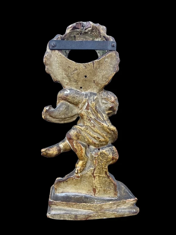 Carved wooden clock stand with gold leaf, depicting a boy