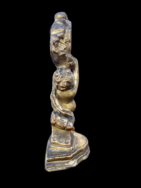 Carved wooden clock stand with gold leaf, depicting a boy