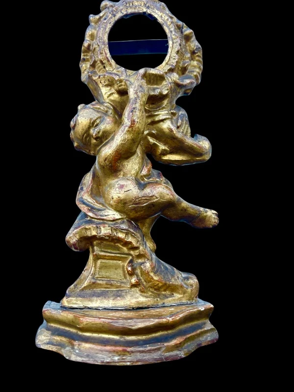 Carved wooden clock stand with gold leaf, depicting a boy
