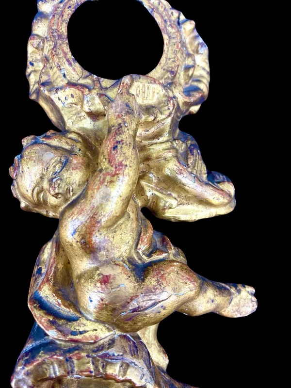 Carved wooden clock stand with gold leaf, depicting a boy