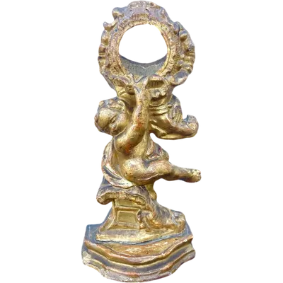 Carved wooden clock stand with gold leaf, depicting a boy