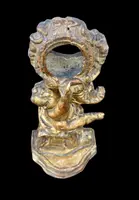 Carved wooden clock stand with gold leaf, depicting a boy