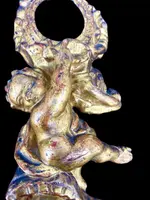 Carved wooden clock stand with gold leaf, depicting a boy