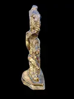 Carved wooden clock stand with gold leaf, depicting a boy