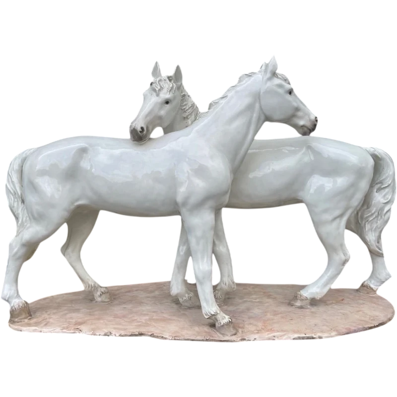 Ceramic sculpture with a base depicting a pair of horses. Made by Mollica.