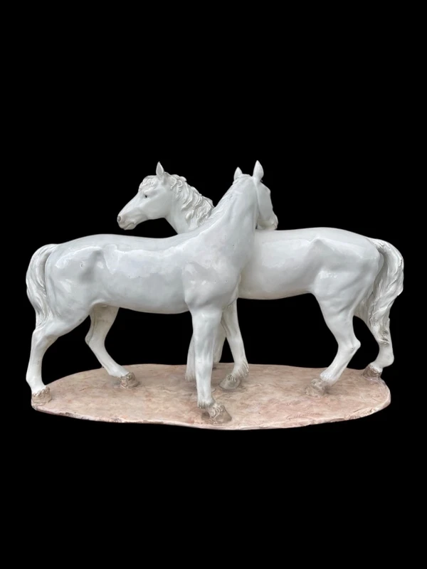 Ceramic sculpture with a base depicting a pair of horses. Made by Mollica.