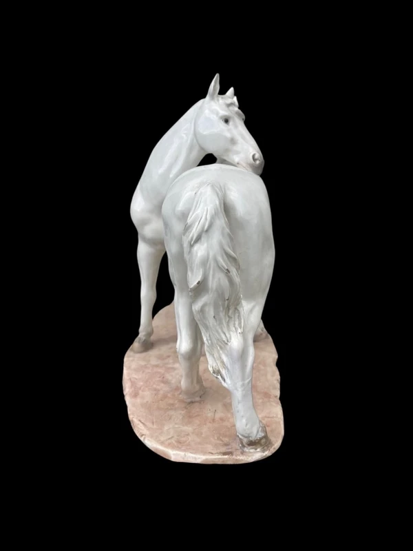 Ceramic sculpture with a base depicting a pair of horses. Made by Mollica.