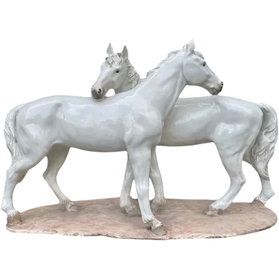 Ceramic sculpture with a base depicting a pair of horses. Made by Mollica.