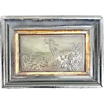 A horn bas-relief with a wooden frame depicting the Ascension of Christ.