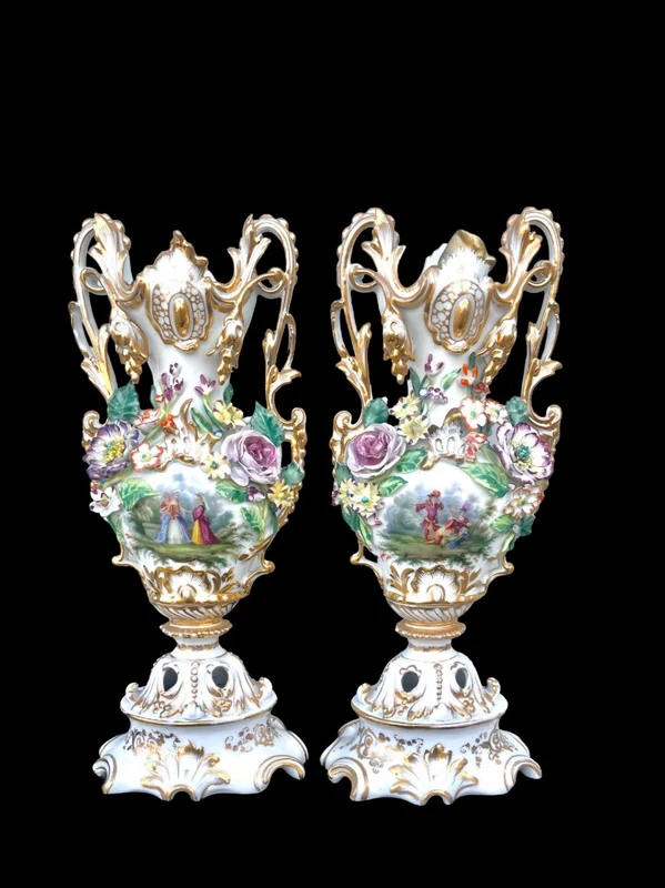 Pair of porcelain vases with two handles, featuring flowers in relief and plant motifs