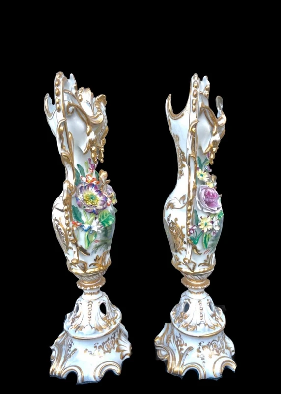 Pair of porcelain vases with two handles, featuring flowers in relief and plant motifs