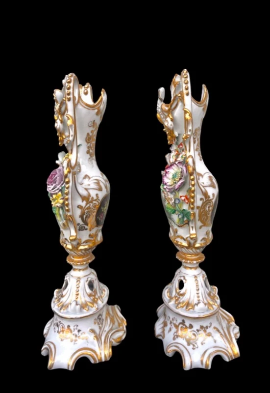Pair of porcelain vases with two handles, featuring flowers in relief and plant motifs