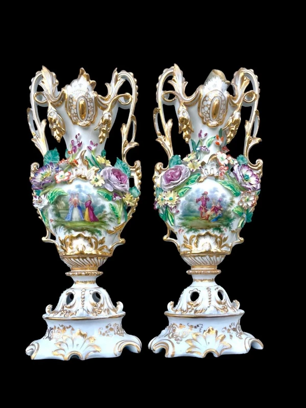 Pair of porcelain vases with two handles, featuring flowers in relief and plant motifs