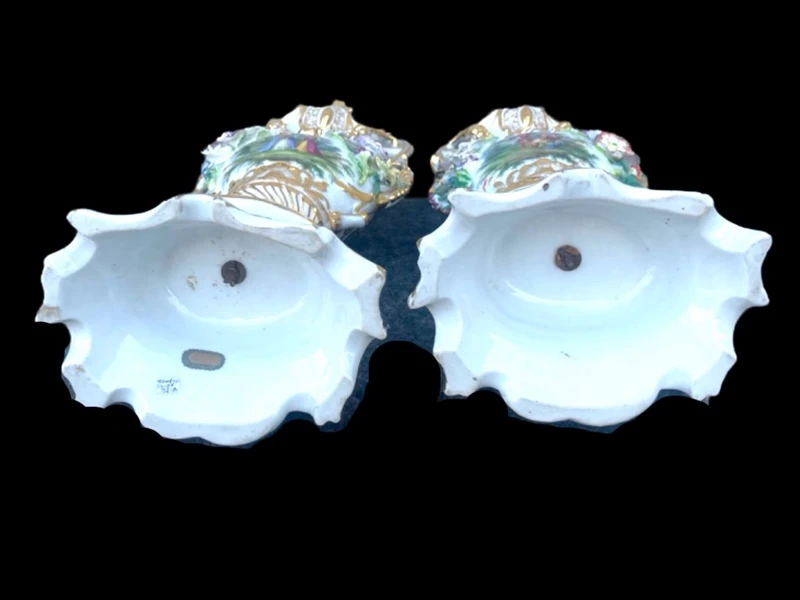 Pair of porcelain vases with two handles, featuring flowers in relief and plant motifs