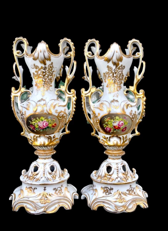 Pair of porcelain vases with two handles, featuring flowers in relief and plant motifs