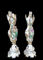 Pair of porcelain vases with two handles, featuring flowers in relief and plant motifs