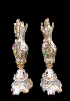Pair of porcelain vases with two handles, featuring flowers in relief and plant motifs