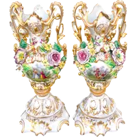 Pair of porcelain vases with two handles, featuring flowers in relief and plant motifs