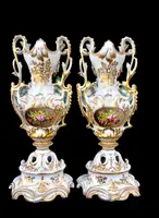 Pair of porcelain vases with two handles, featuring flowers in relief and plant motifs