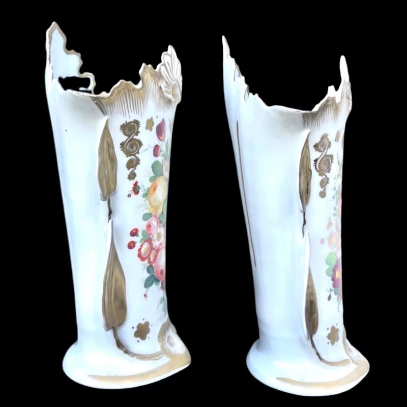 Pair of trumpet-shaped porcelain vases with leaf-shaped handles and floral motifs in relief
