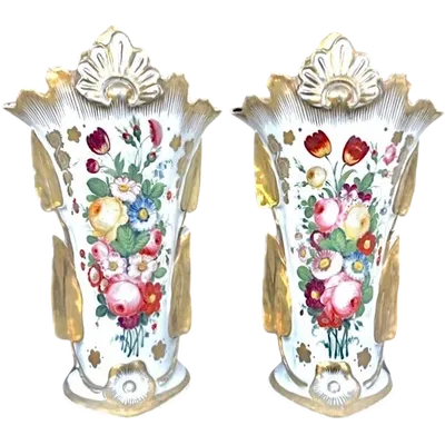 Pair of trumpet-shaped porcelain vases with leaf-shaped handles and floral motifs in relief