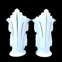 Pair of trumpet-shaped porcelain vases with leaf-shaped handles and floral motifs in relief