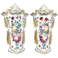 Pair of trumpet-shaped porcelain vases with leaf-shaped handles and floral motifs in relief