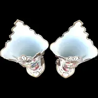 Pair of trumpet-shaped porcelain vases with leaf-shaped handles and floral motifs in relief