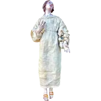 Nativity scene figurine with a terracotta face and a frame made of wood and fabric.