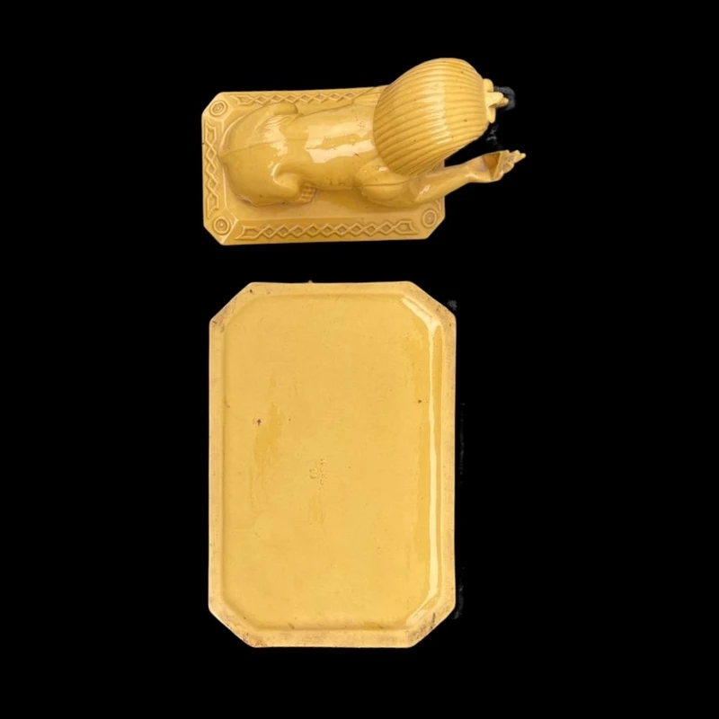 Mustard-colored earthenware box decorated with sphinxes and neoclassical motifs.