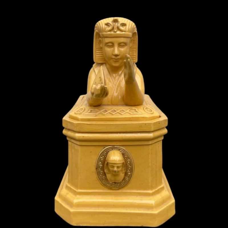 Mustard-colored earthenware box decorated with sphinxes and neoclassical motifs.