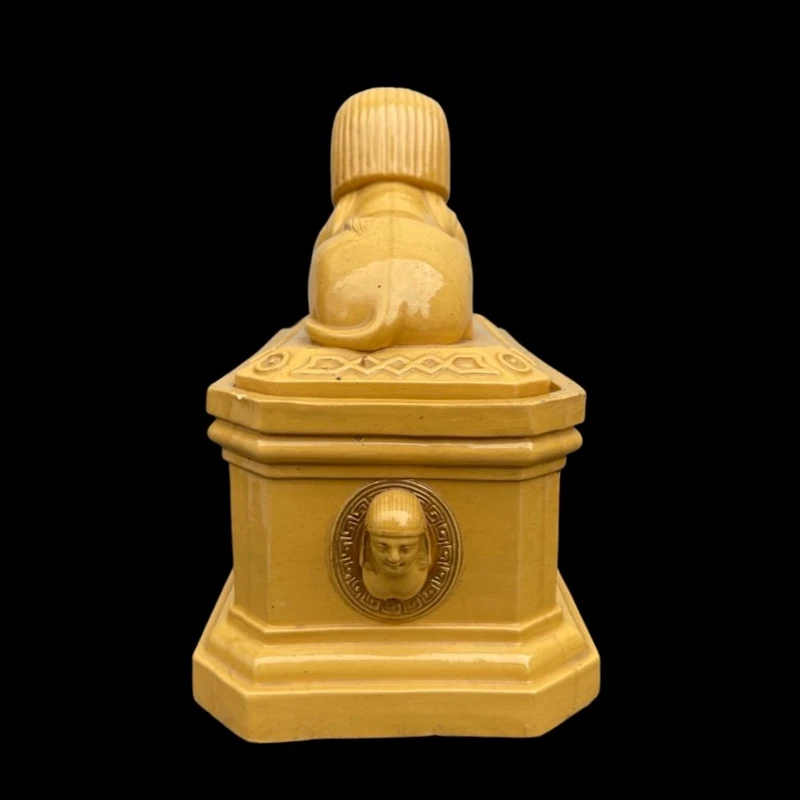 Mustard-colored earthenware box decorated with sphinxes and neoclassical motifs.