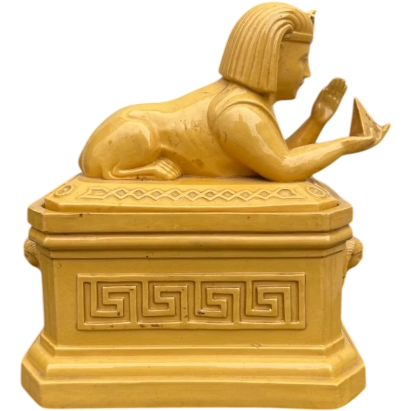 Mustard-colored earthenware box decorated with sphinxes and neoclassical motifs.
