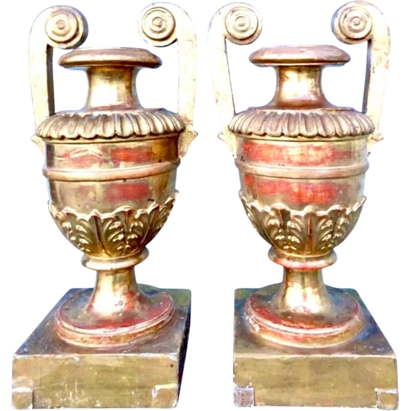 A pair of neoclassical palm-shaped candleholders made of gilded wood with stylized leaf motifs.